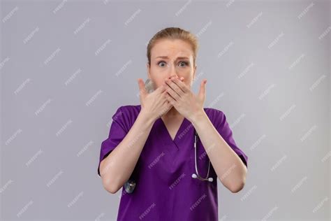 Free Photo Surprised Doctor Young Girl Wearing Purple Medical Gown And Stethoscope Covered