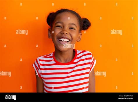 Portrait Of Happy African American Schoolgirl Laughing Over Orange