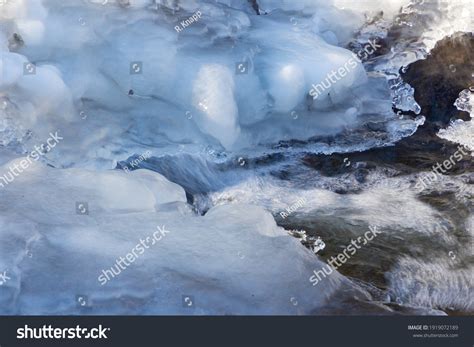Flowing Water Under Melting Ice Concept Stock Photo 1919072189