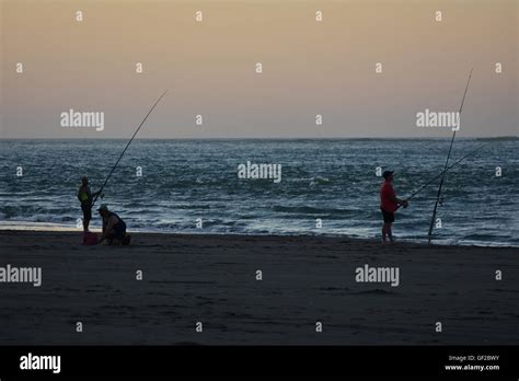Men Fishing At Dusk Stock Photo Alamy