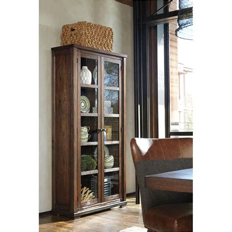 The mixed media appeal combines dark finish metal accents with the natural beauty of mindi veneer in a rich brown finish. D670-70 Ashley Furniture Zenfield - Charcoal Dining Room Curio