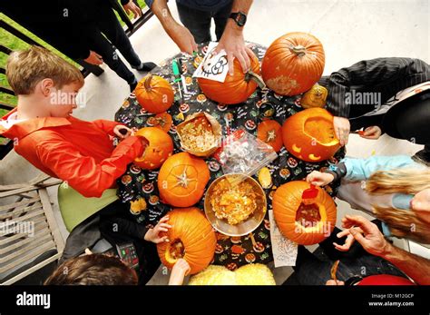 Overhead View Of Kids Carving Pumpkins Nice Orange Scene Halloween