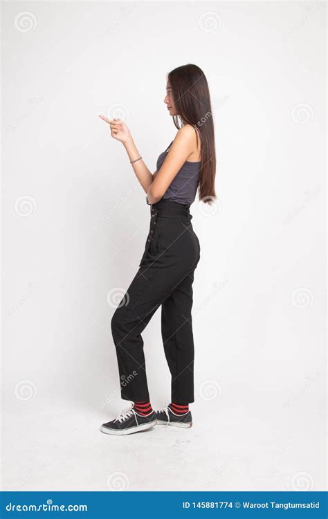 Full Body Side View Of Beautiful Young Asian Woman Pointing Stock Photo