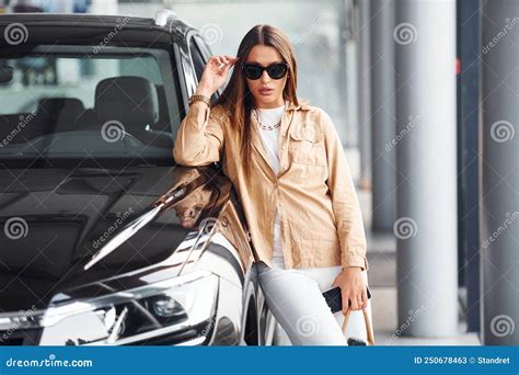 Leaning On The Car Fashionable Beautiful Young Woman And Her Modern