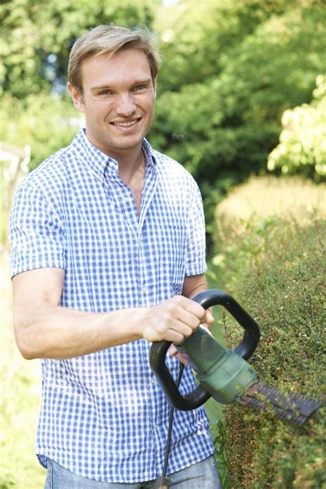 Man Cutting Garden Hedge With Electric Trimmer Stock Image Image Of