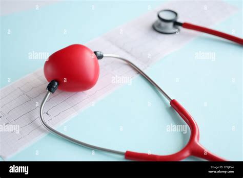 Red Toy Heart And Stethoscope Lying On Cardiogram Closeup Stock Photo