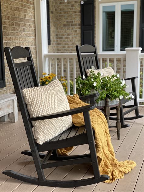 For a business owner, the main purpose of the rocking chair would be for entertaining. Front porch with black rocking chairs and a mustard yellow ...