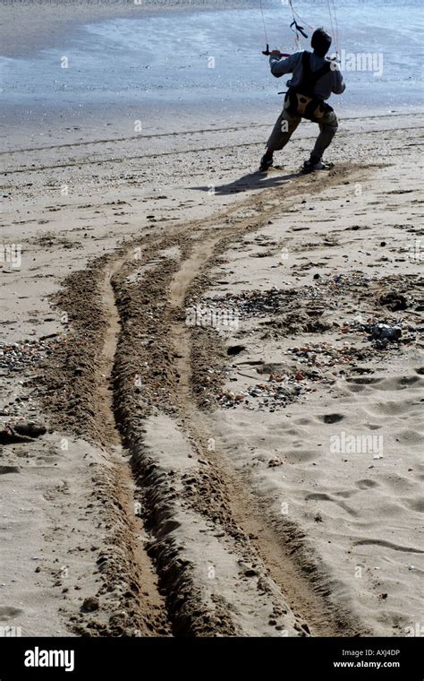 Man Being Dragged Along A Beach By His Surfing Kite Stock Photo Alamy