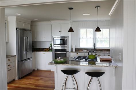 This incorporation can be added to any room in a home making it a well along space. Small Beach House Lives Big - Beach Style - Kitchen ...