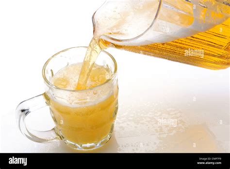 A Pitcher Of Beer Pouring Into A Mug On A Wet Bar Counter Horizontal