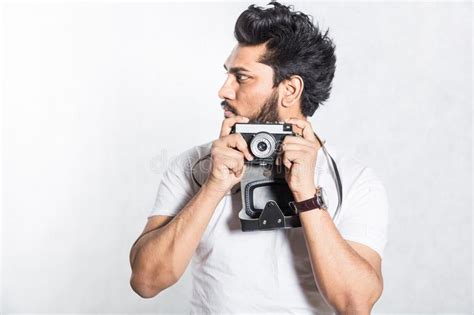 Portrait Of A Handsome Young Stylish Man With Beard Taking Photo On A