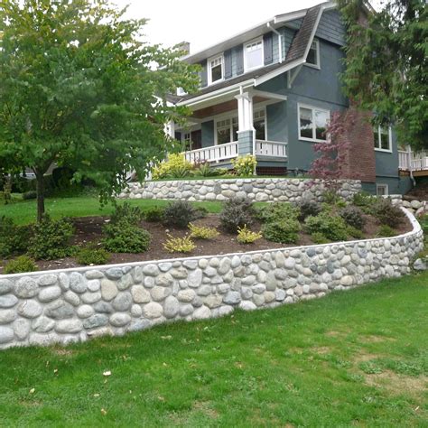 River Rock Retaining Wall But With Bigger Stones More Loosely Formed