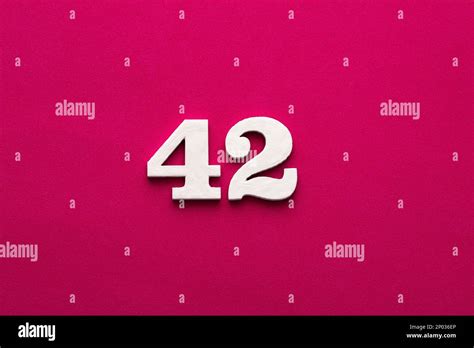 Number 42 White Wooden Number On Rhodamine Red Background Stock Photo