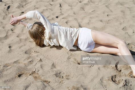 Woman Lying Down On Sand Bildbanksbilder Getty Images