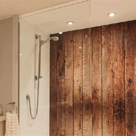A Bathroom With Wood Paneling On The Wall And Shower Head Mounted To