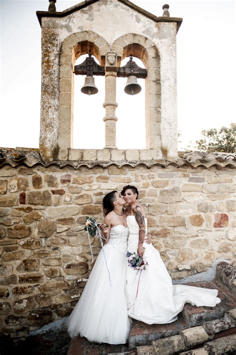 Tying a ribbon across the doorway of the church lets passersby's know that your wedding is taking place. Rainbow Italian wedding in Cagliari