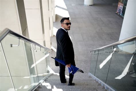 Free Photo Businessman In Suit And Sunglasses Walking Down Staircase