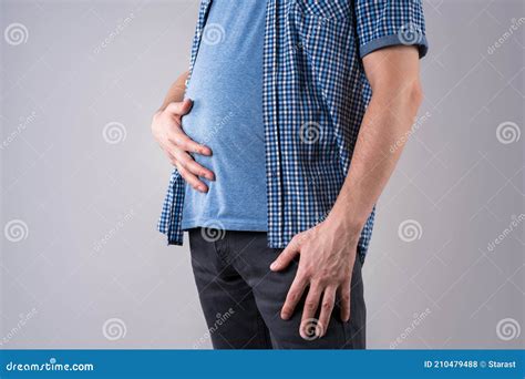 Fat Man With Bloating And Abdominal Pain Overweight Male Body On Gray