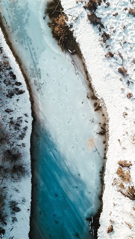 Aerial Photography Of River Beside Snow Field Iphone Wallpapers Free