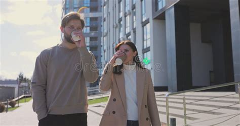 Cheerful Couple Walking Through The City Together Couple Drinking Take