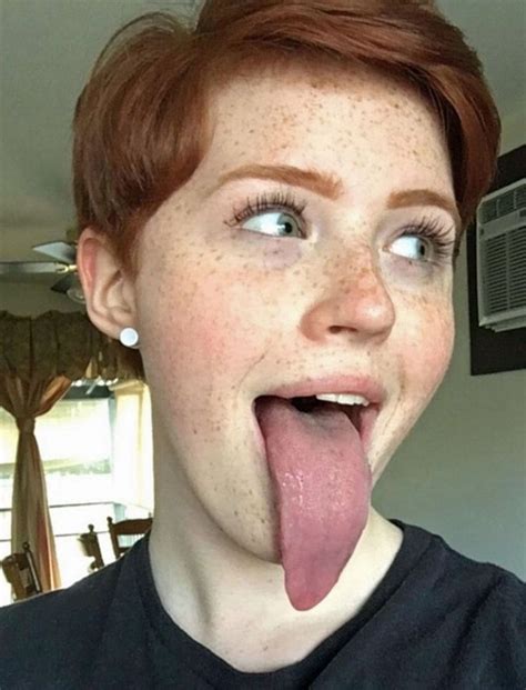 A Woman Sticking Her Tongue Out And Making A Funny Face