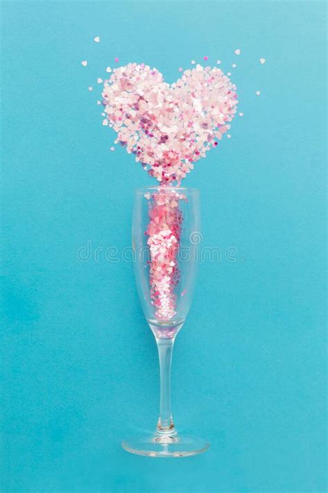 Valentine S Day Champagne Glasses With Pink Confetti In The Shape Of Heart On Light Blue