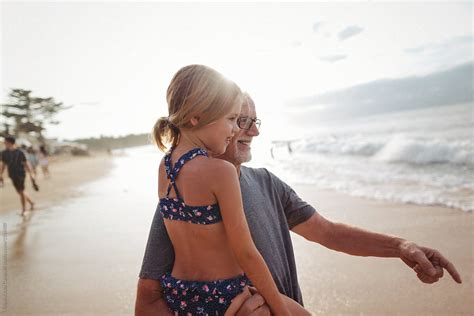 Active Happy Grandpa Having Fun With Granddaughter On Beach Vac Del