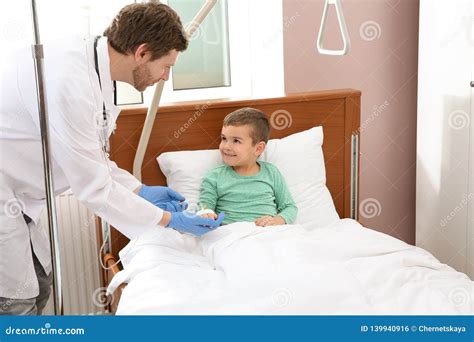 Doctor Adjusting Intravenous Drip For Little Child Stock Photo Image
