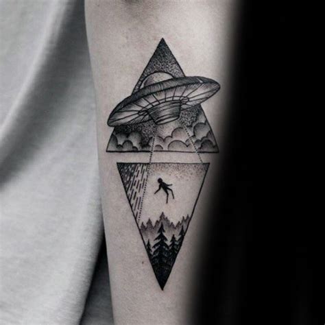 A Mans Arm With An Alien Flying Over The Mountains And Trees On It