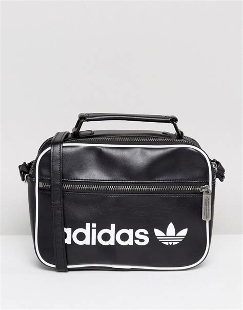 When you're feeling like flying with your hands free, toss your essentials into this adidas mini airliner bag and check the rest. adidas Originals Originals Vintage Mini Airliner Bag In ...