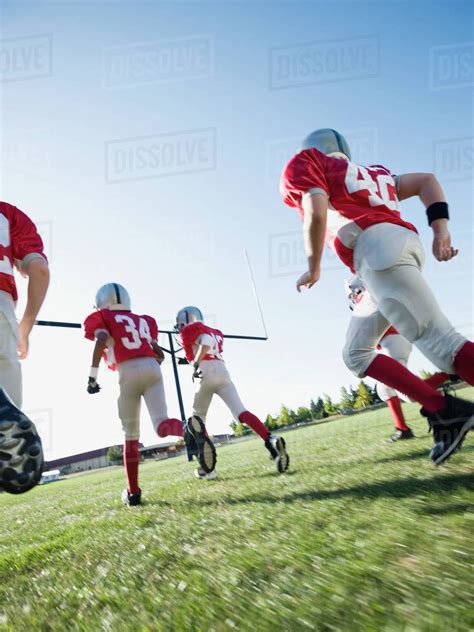 Football Players Running On Field Stock Photo Dissolve