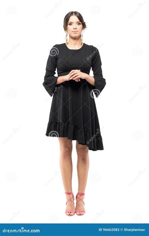 Standing Classy Formal Woman In Black Dress With Hand Clasped Looking At Camera Stock Image
