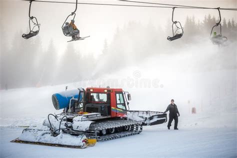 Snow Cleaning Machine Working On Ski Slope Under Cable Chairs Editorial