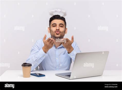 Romantic Handsome Businessman Sitting In Office Workplace With Saint