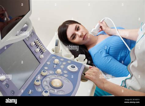 Doctor Using Ultrasound Scanning Machine Examining Female Neck Stock