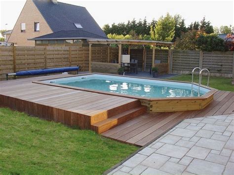 An Above Ground Pool With Steps Leading Up To It And A Deck In The Middle