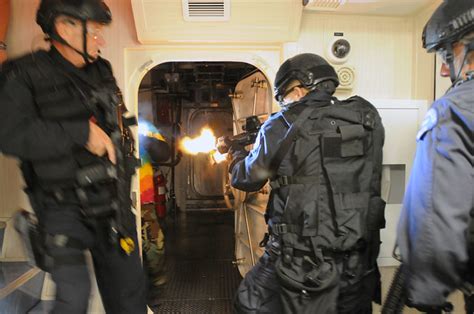 Swat Team Members Breach A Room And Engage Hostile Targets In A