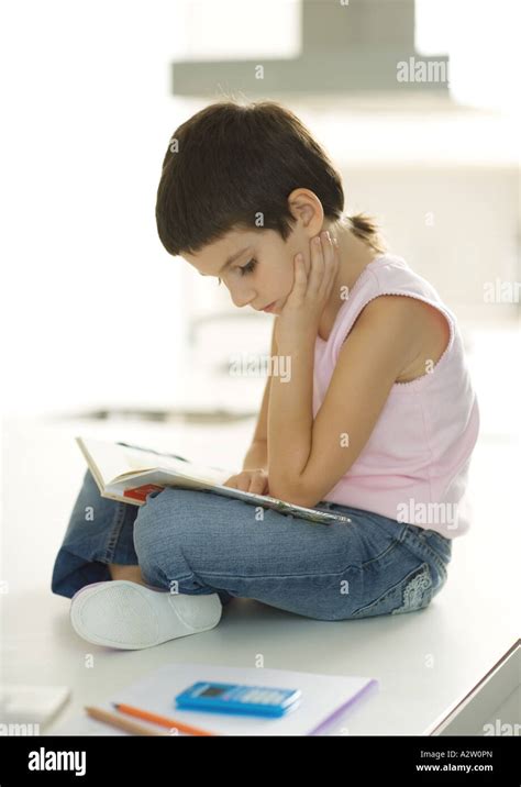 Child Sitting Reading Book Stock Photo Alamy