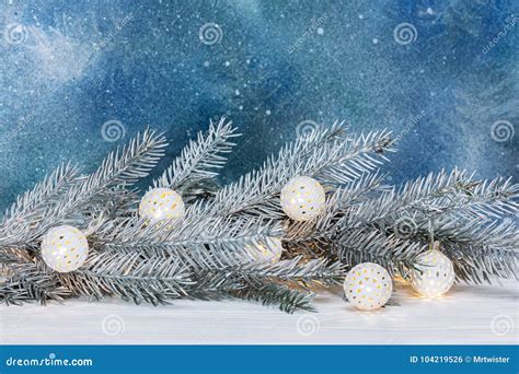Silver Christmas Tree Branch And Decorative Retro Garland On Blu Stock