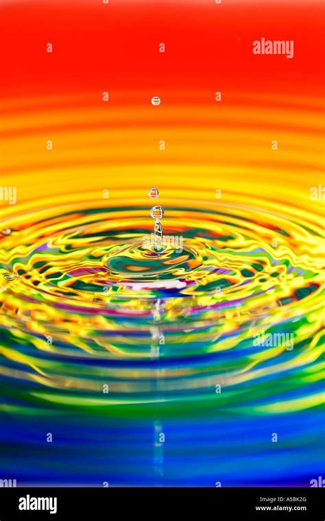 Rainbow Water Drop Ripples Water On A Plate Mirror With Reflected