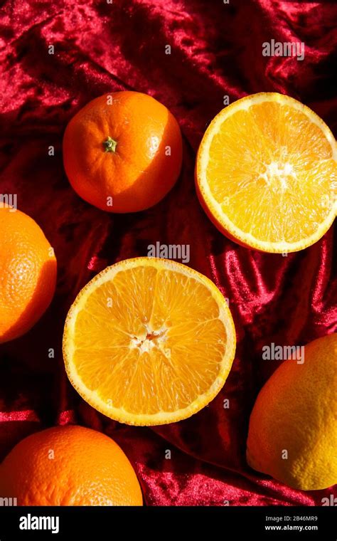 Tangerines And Oranges On Red Velvet Background Citrus Fruits Still