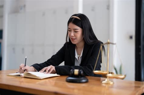 Premium Photo Portrait Confidence Asian Lawyer Taking Note Sitting At
