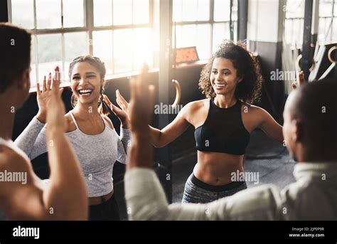Fitness made fun. a group of young people working out together in a gym