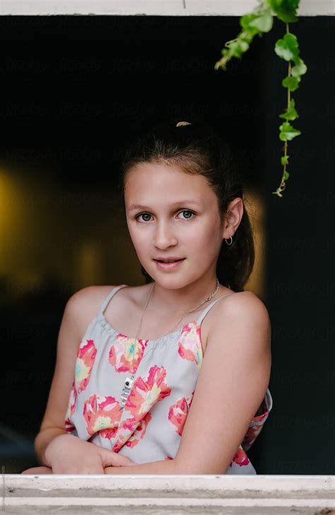 Pretty Teen Girl Smiling From Her Window By Stocksy Contributor