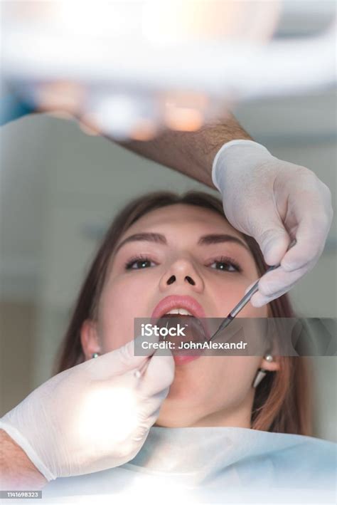 Doctor Orthodontist Examines The Oral Cavity Of A Beautiful Patient