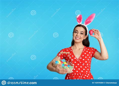 Beautiful Woman In Bunny Ears Headband Holding Basket With Easter Eggs