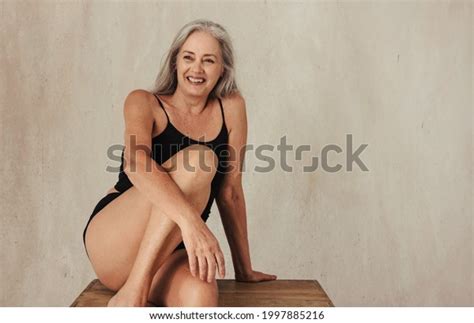 Smiling Mature Woman Wearing Black Underwear Stock Photo