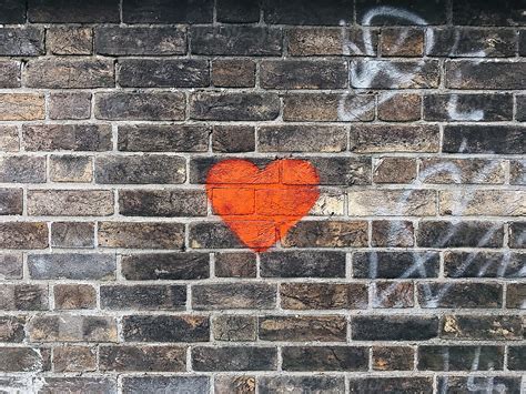 Red Heart Painted On A Brick Wall By Stocksy Contributor Sam Burton