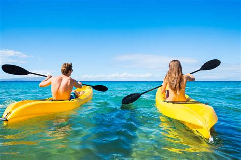 Man And Woman Kayaking In The Ocean KayaKudos