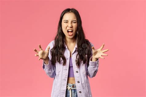 Portrait Of Aggressive Young Bothered Girl Losing Temper Screaming